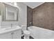 Modern bathroom features a shower and tub combo with dark tile and a vanity sink with white cabinets at 10906 Johanna Ave, Riverview, FL 33578