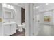 Bathroom featuring a modern vanity, toilet, and tiled shower/bath combo, with wood-look flooring at 10906 Johanna Ave, Riverview, FL 33578