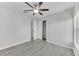 Bedroom featuring neutral paint, wood-look floors, a modern fan, and closet with double doors at 10906 Johanna Ave, Riverview, FL 33578