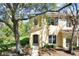 Charming two-story home with neutral siding, complemented by lush landscaping and mature trees at 10906 Johanna Ave, Riverview, FL 33578