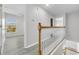 Upstairs hallway showcasing modern design, bright lighting, and seamless flow to the rooms at 10906 Johanna Ave, Riverview, FL 33578