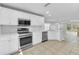 Modern kitchen with stainless steel appliances, white cabinets, and an adjacent eat-in area at 10906 Johanna Ave, Riverview, FL 33578