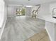 Open-concept living room featuring modern flooring, natural light, and a seamless flow to the outdoor space at 10906 Johanna Ave, Riverview, FL 33578