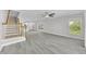 Open-concept living area with modern flooring, natural light, and seamless flow to kitchen at 10906 Johanna Ave, Riverview, FL 33578