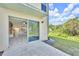 View from the patio, showing the open-concept interior layout with wood-look flooring and modern kitchen at 10906 Johanna Ave, Riverview, FL 33578