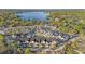 Aerial view of townhouses featuring a pond and a community pool surrounded by lush green trees and foliage at 12253 Armenia Gables Cir # 12253, Tampa, FL 33612