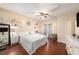 Bedroom features hard wood floors, a ceiling fan, and decorative shelves at 12253 Armenia Gables Cir # 12253, Tampa, FL 33612