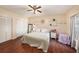 Bedroom features hard wood floors, a ceiling fan, a closet and a window at 12253 Armenia Gables Cir # 12253, Tampa, FL 33612