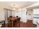 Inviting dining area featuring hardwood floors, a modern chandelier, and adjacent kitchen access at 12253 Armenia Gables Cir # 12253, Tampa, FL 33612