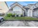 Inviting condo exterior with a large arched window and well-manicured lawn at 12253 Armenia Gables Cir # 12253, Tampa, FL 33612