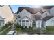 Exterior view of a townhouse featuring large windows, stairs to the second level, and a small landscaped yard at 12253 Armenia Gables Cir # 12253, Tampa, FL 33612