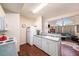 Traditional kitchen featuring white cabinets and appliances that opens into a living room at 12253 Armenia Gables Cir # 12253, Tampa, FL 33612