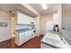 Traditional kitchen featuring white cabinets and appliances with hard wood flooring at 12253 Armenia Gables Cir # 12253, Tampa, FL 33612