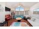 Spacious living room featuring a vaulted ceiling, large arched window, and hardwood flooring at 12253 Armenia Gables Cir # 12253, Tampa, FL 33612