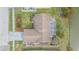 Aerial view of home showcasing landscaping, screened lanai and waterfront access at 1232 Persimmon Dr, Holiday, FL 34691