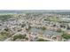 Aerial view highlighting the tranquil lake community with tree-lined streets and diverse homes at 1232 Persimmon Dr, Holiday, FL 34691