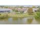 Lush backyard featuring lawn, white picket fence, and waterfront views at 1232 Persimmon Dr, Holiday, FL 34691
