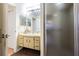 Bathroom featuring a vanity, cabinets and enclosed shower, with fixtures in a neutral color scheme at 1232 Persimmon Dr, Holiday, FL 34691