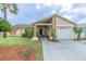 Charming home featuring stone accents, well-manicured lawn, and a welcoming entrance at 1232 Persimmon Dr, Holiday, FL 34691
