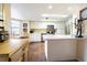 Bright kitchen with white cabinets and counter tops and open breakfast bar at 1232 Persimmon Dr, Holiday, FL 34691
