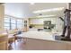 Well-lit kitchen with white cabinets, stainless appliances, and a breakfast nook at 1232 Persimmon Dr, Holiday, FL 34691