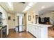 Kitchen features white cabinets, stainless appliances, and a tiled floor at 1232 Persimmon Dr, Holiday, FL 34691