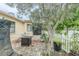 Enclosed patio features outdoor seating, fire pit, and access to the backyard and waterfront at 1232 Persimmon Dr, Holiday, FL 34691