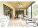 Enclosed lanai with tile flooring, ceiling fan, and casual seating, creating an inviting and relaxing space at 1232 Persimmon Dr, Holiday, FL 34691