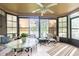 Bright sunroom featuring a ceiling fan, tile floors, multiple windows offering serene water views at 1232 Persimmon Dr, Holiday, FL 34691