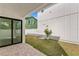 A well-maintained backyard with a small palm tree and modern sliding glass doors at 1239 36Th N Ave, St Petersburg, FL 33704