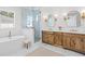 Bright bathroom featuring a soaking tub, walk-in shower, double vanity and marble tile floor at 1239 36Th N Ave, St Petersburg, FL 33704