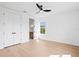Bright bedroom featuring light wood floors, a ceiling fan, a double door closet, and a window at 1239 36Th N Ave, St Petersburg, FL 33704