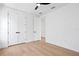 Bedroom featuring hardwood floors, white walls and double doors to a closet at 1239 36Th N Ave, St Petersburg, FL 33704