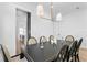 Dining room with a dark wood table, decorative chandelier, and open view to kitchen at 1239 36Th N Ave, St Petersburg, FL 33704