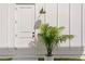 Front door with black hardware and a palm tree next to it at 1239 36Th N Ave, St Petersburg, FL 33704