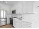 Kitchen featuring white cabinets, stainless steel appliances, and a white countertop at 1239 36Th N Ave, St Petersburg, FL 33704