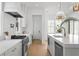 Modern kitchen with stainless steel appliances, marble countertops, and wood floors at 1239 36Th N Ave, St Petersburg, FL 33704