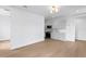 Living room area open to kitchen with stainless steel appliances and white cabinetry at 1239 36Th N Ave, St Petersburg, FL 33704