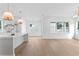 Open-concept living space with hardwood floors, natural light, and modern kitchen views at 1239 36Th N Ave, St Petersburg, FL 33704
