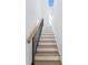 Staircase with hardwood treads, white risers, and a modern black railing at 1239 36Th N Ave, St Petersburg, FL 33704