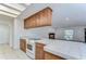 Bright kitchen featuring tile countertops, wooden cabinets, and an open layout with natural lighting at 127 Windy Pl, Brandon, FL 33511