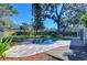 Backyard pool surrounded by a paver patio and wooden deck, all enclosed by a wooden fence for privacy at 127 Windy Pl, Brandon, FL 33511