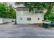 Back of home with neutral siding and gravel yard and rear entry at 129 18Th N Ave, St Petersburg, FL 33704