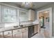 Charming kitchen featuring granite countertops, white cabinets, stainless dishwasher, and a double sink at 129 18Th N Ave, St Petersburg, FL 33704