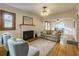Open living room with hardwood floors, a brick fireplace, and natural light at 129 18Th N Ave, St Petersburg, FL 33704