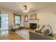 Cozy living room with hardwood floors, a fireplace, and comfortable seating at 129 18Th N Ave, St Petersburg, FL 33704