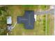 Aerial view of charming home on a large lot, featuring two outbuildings, a driveway, and landscaping at 1413 Lithia Pinecrest Rd, Brandon, FL 33511