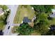 Aerial view of property showcasing house, outbuildings, mature trees and adjacent road at 1413 Lithia Pinecrest Rd, Brandon, FL 33511