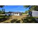 Exterior view of a well-kept home featuring a large yard with mature trees, providing privacy and shade at 1413 Lithia Pinecrest Rd, Brandon, FL 33511
