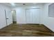 A bright bedroom features hardwood floors, a closet, and a doorway leading to another room at 1413 Lithia Pinecrest Rd, Brandon, FL 33511